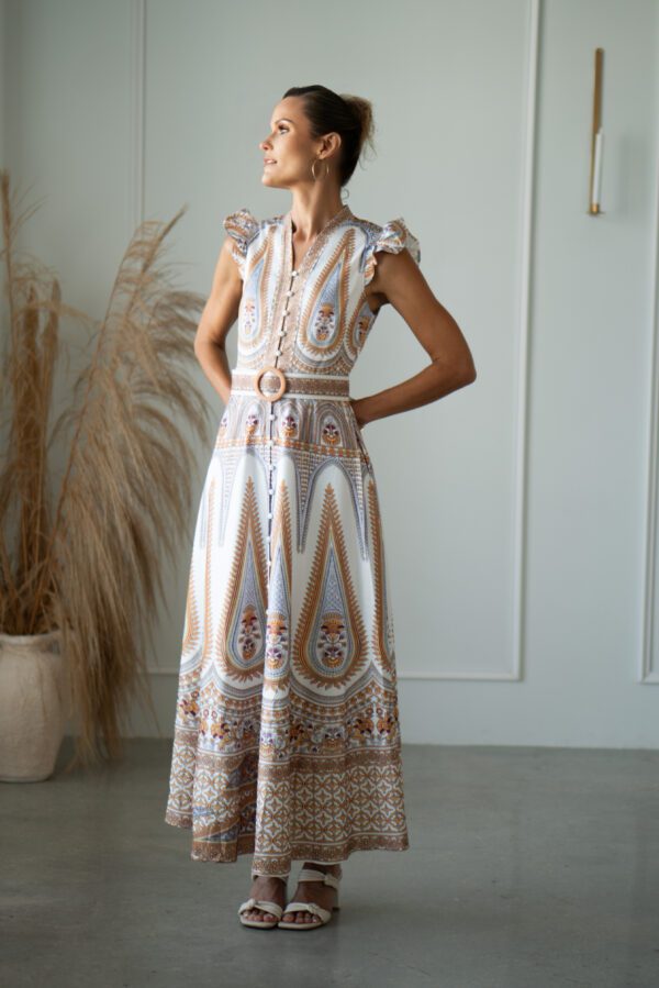 Woman in patterned maxi dress with belt.